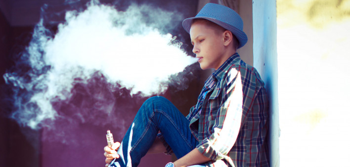 well dressed teen vaping e cigarette