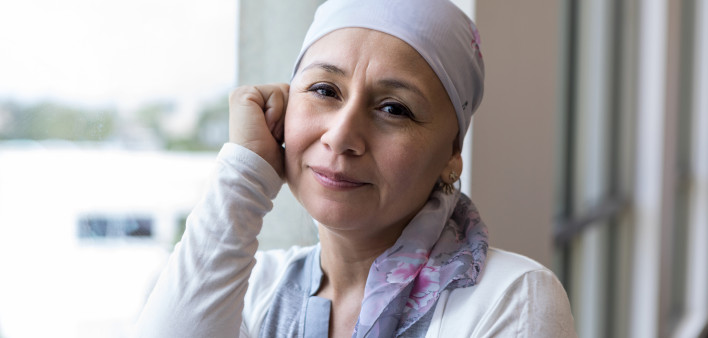 A peaceful photo of a breast cancer patient wearing a scarf to cover her head.