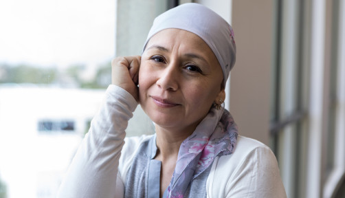 A peaceful photo of a breast cancer patient wearing a scarf to cover her head.