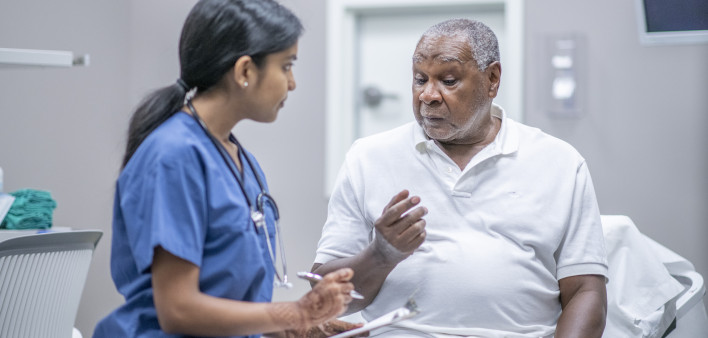 nurse talking to black doctor