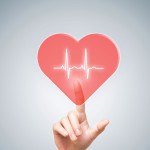finger touching heart with heartbeat line