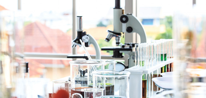 beakers and microscopes in laboratory