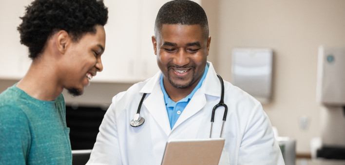Doctor and patient looking at digital tablet in exam
