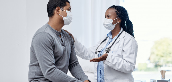black doctor taklking to latin patient
