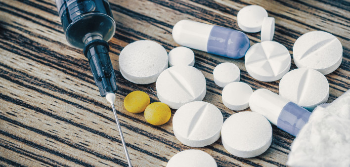 syringe and pills