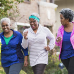 Three senior black women exercising together