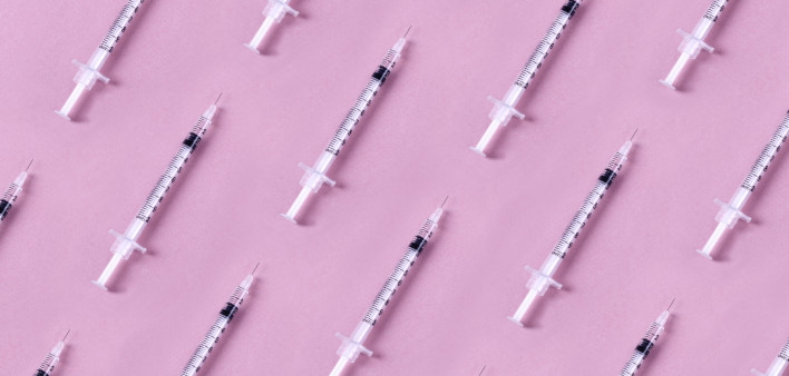 Syringes on pink background vaccine