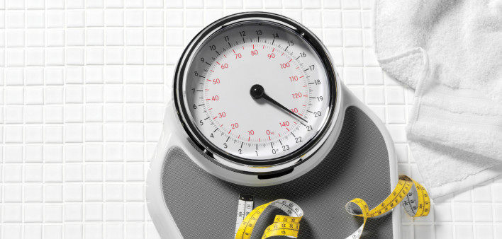 scale and tape measure on tile floor