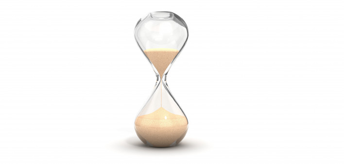 an hourglass with sand running downwards