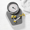 scale and tape measure on tile floor