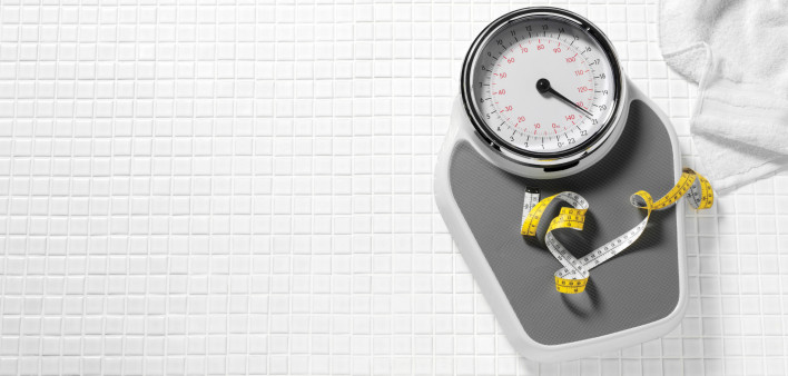 scale and tape measure on tile floor