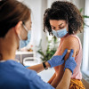 Nurse giving vaccine to patient