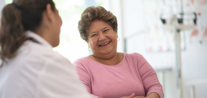 Older Woman talking with the Doctor laughing