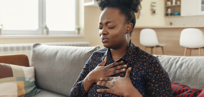 Pressure in the Chest. Close-up Photo of a Stressed Obese African American Woman Who Is Suffering From a Chest Pain and Touching Her Heart Area.