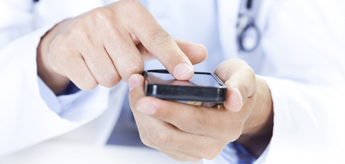  a doctor touching a smart phone