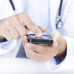  a doctor touching a smart phone