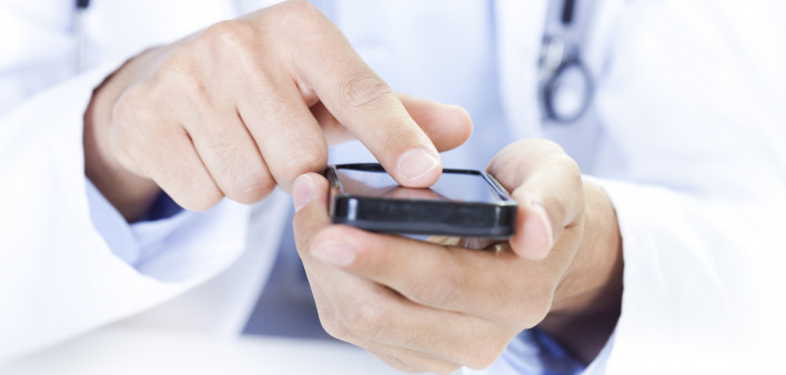  a doctor touching a smart phone