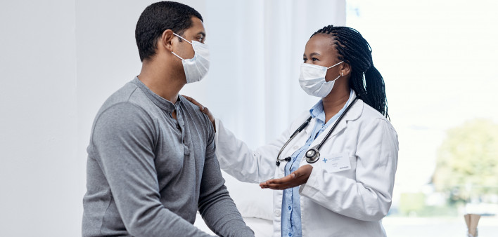 black doctor taklking to latin patient