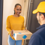 Deliveryman giving medications to customer