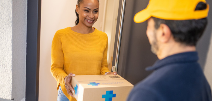 Deliveryman giving medications to customer