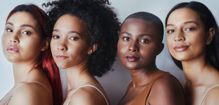 Black women tudio shot of a group of beautiful young women posing together against a gray background