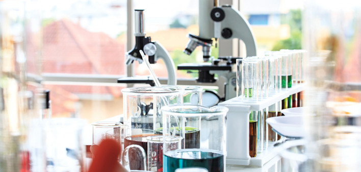 beakers and microscopes in laboratory