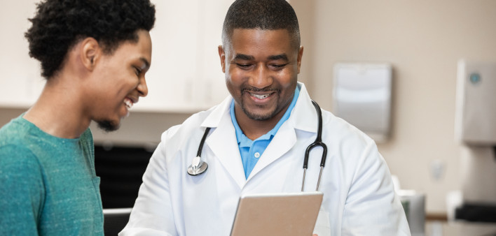 Doctor and patient looking at digital tablet in exam