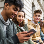 Teenagers students using smartphone on a school break