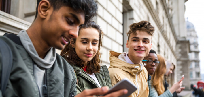 Teenagers students using smartphone on a school break