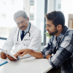 Cropped shot of a mature male doctor and patient having a discussion in the doctor's office before a checkup