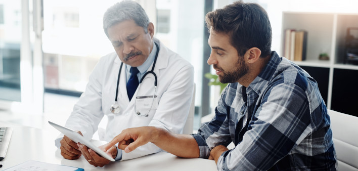 Cropped shot of a mature male doctor and patient having a discussion in the doctor's office before a checkup