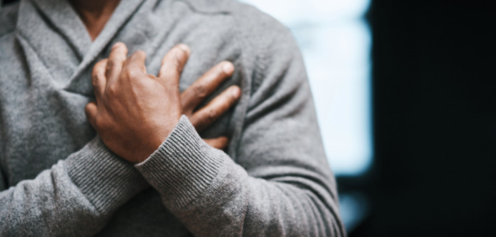 African American Man holding chest pain heart