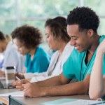 Diverse pre-med students take notes during class