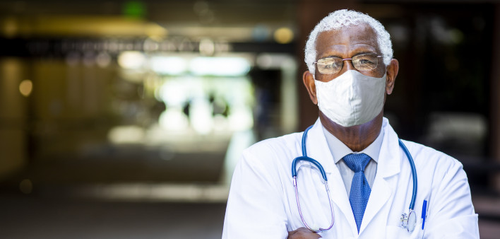 Portrait of a senior African American doctor at the hospital wearing a mask