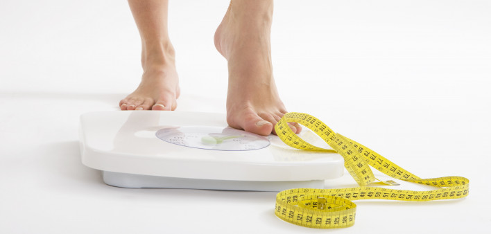 bare feet on scale and measuring tape