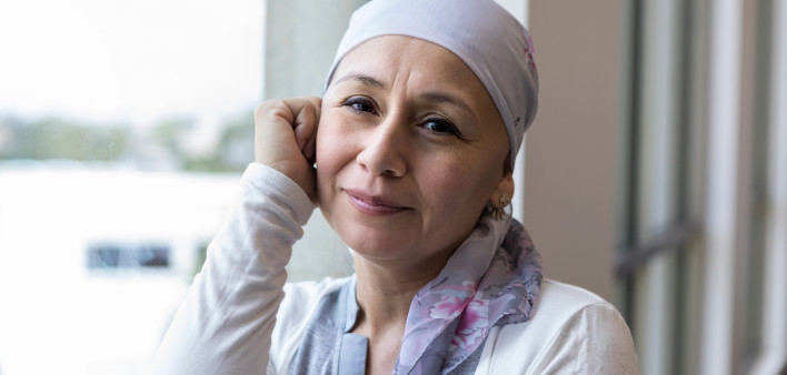 A peaceful photo of a breast cancer patient wearing a scarf to cover her head.