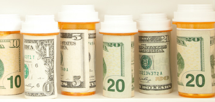 pill bottles with money as labels cost of healthcare