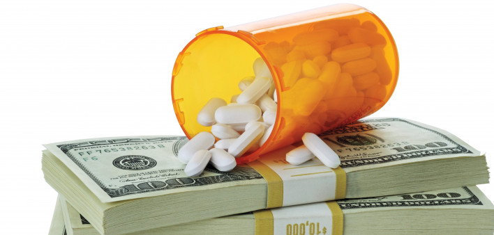 cost of healthcare bottle of pills on money