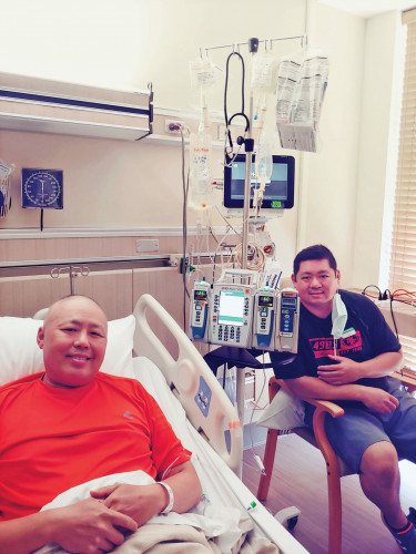 Charlie Huang, left, with his brother, Denny