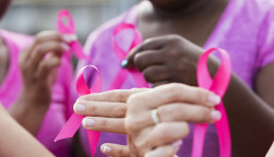 Multi-ethnic women with breast cancer awareness ribbons