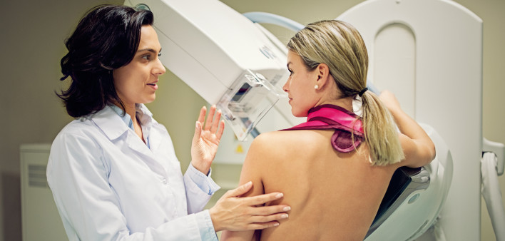 Doctor is working with mammography X-ray scanner in hospital