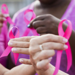 Multi-ethnic women with breast cancer awareness ribbons