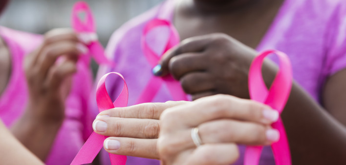 Multi-ethnic women with breast cancer awareness ribbons