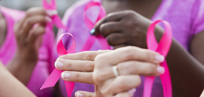 Multi-ethnic women with breast cancer awareness ribbons
