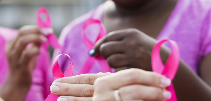Multi-ethnic women with breast cancer awareness ribbons