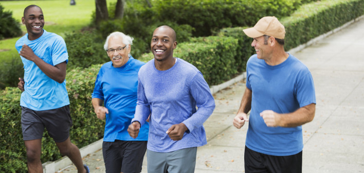 Four multiracial men jogging in park - Stock image Men, Only Men, Running, Multi-Ethnic Group, Exercising