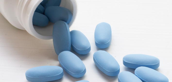 blue pills spilling out of bottle
