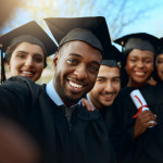 Portrait of a group of students taking selfies on graduation day