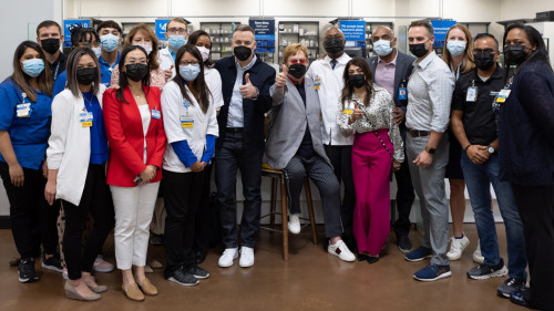 Elton John and David Furnish, center, join Walmart staff to launch more HIV-focused Specialty Pharmacies of the Community.