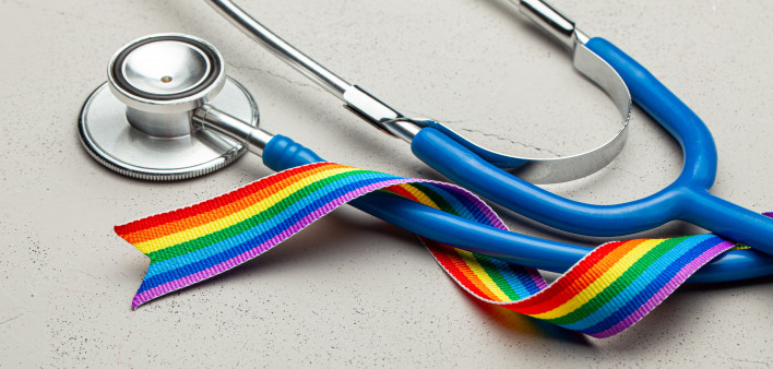 Stethoscope and LGBT rainbow ribbon pride tape symbol. Medical support after sex reassignment surgery.